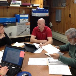 Edgecomb Selectmen Jessica Chubbuck, left, Stuart Smith and Jack Sarmanian discuss Chubbuck's proposal for 1 percent pay hikes. SUSAN JOHNS/Wiscasset Newspaper
