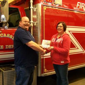 Wiscasset Fire Chief Ron Bickford congratulates Amanda Cloutier, the grand prize winner of the NASCAR race tickets, sponsored by the Association of Wiscasset Firefighters. Courtesy of the Association of Wiscasset Firefighters