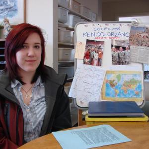 Helena Solorzano with a copy of the letter her soldier father wrote to thank his daughter's school for donations to children in Afghanistan. In the background is information the school gathered about Ken Solorzano and the country where he is currently serving. SUSAN JOHNS/Wiscasset Newspaper