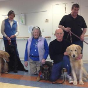 Jean Conte's current dog therapy teams in training on April 4 at the Lincoln Home in Newcastle. From left, Martha Tait and four-year-old Golden Retriever Mollie, Carolyn Ray and one-and-a-half-year-old Labrador Retriever Jack, Conte and her TDI certified German Shepherd, Maya, Joel Russ and three-year-old Golden Nell, and standing behind them, Richard Blouin and Millie, a 15-month-old American Bulldog. Below: Mollie in a simulated arrival at a facility where a “staff member” greets the team, and Bob and Jana Beattie, residents of the Lincoln Home, enjoy a few minutes greeting 15-month-old Millie during the dog therapy preparation course led by Conte April 4. LISA KRISTOFF/Boothbay Register Jean Conte's current dog therapy teams in training on April 4 at the Lincoln Home in Newcastle. From left, Martha Tait and four-year-old Golden Retriever Mollie, Carolyn Ray and one-and-a-half-year-old Labrador Retriever Jack, Conte and her TDI certified German Shepherd, Maya, Joel Russ and three-year-old Golden “Nell,” and standing behind them, Richard Blouin and Millie, a 15-month-old American Bulldog. LISA KRISTOFF/Boothbay Register