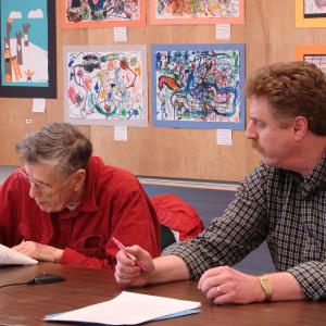 William Curtis, left, and Jeff Slack take turns signing the June 11 Wiscasset town meeting warrant. SUSAN JOHNS/Wiscasset Newspaper