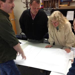 Resident Mike Ware and selectmen look over a preliminary plan for a proposed town office addition. JOHN MAGUIRE/Wiscasset Newspaper
