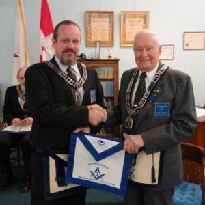 Curtis W. West, right, receives his Life Member apron from Worshipful Mike Leighton. Courtesy of Gary Tilton