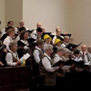 Tapestry singers performing lighter fare (note silly hats!) in April. Courtesy of Rosie Bensen