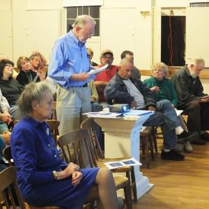 Wright committee member Richard DeVries presented a signed petition asking the town to hold the Wright property “in perpetuity” for public use. In the foreground is Ann Dowrick, who currently lives in the Wright house and pays rent to the town. JOHN MAGUIRE/Wiscasset Newspaper