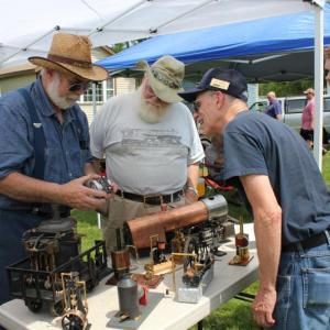 New England Model Engineering Society members Dick Boucher and Ron Ginger explain the inner workings of a scale model device. SUE MELLO/Boothbay Register