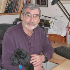 Biographer Fred Kaplan sits at his home office in Boothbay with his black toy poodle Kai as his constant companion. KATRINA CLARK/Boothbay Register