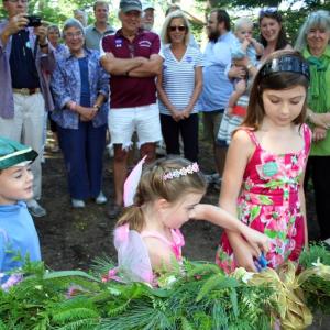 Cutting the beribboned garland at Saturday’s grand reopening of the shorefront Fairy House Village are twins Ronan and Maeve Cullina (age 5) and, at right, Brooklyn Cone (8-1/2). Stone “ruins” and other imaginative structures by Joe Norton add a touch of magic to the Village where visitors at the celebration sprinkled fairy dust, conjured up elaborate fairy houses and made cupcakes disappear. Courtesy of Barbara Freeman