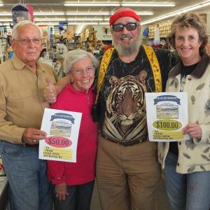 Big Al Cohen hands out contest gift certificates to Mark Powley and his wife and Linda Campbell, right. 