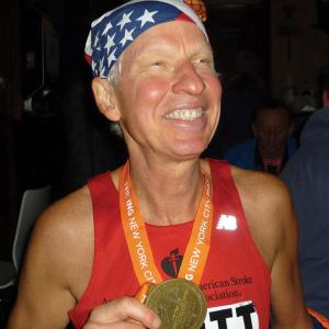 Scott Flagg shows off his medal from the New York City Marathon. Courtesy of Scott Flagg and Janet Martin