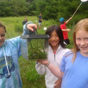 Boothbay Region Land Trust’s environmental educator Tracey Hall provides free environmental education programs to the community including the land trust’s partners. Camp Knickerbocker campers, from left, Mattie, Annalise and Zoey participate in Hall’s wilderness camp and show off a green frog found far from the water during a habitat exploration at Zak Preserve. BRLT is raising endowment to sustain Tracey’s role and the land trust’s Osprey Program. Courtesy of BRLT