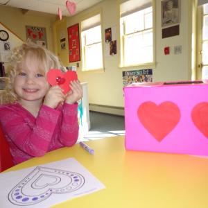 We each pulled a secret valentine from the decorated box, and it is a special origami creation! Grace holds up her origami heart that she pulled from the valentine box. Courtesy of Natalie Castonia