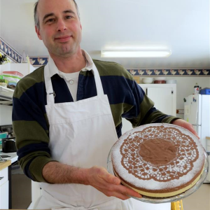 Peter Varns displaying the final result: Black and White Chocolate Mousse Torte. Courtesy of Jackie Lowell Varns
