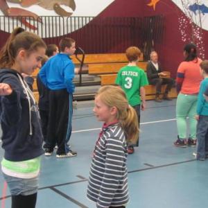 Sixth grader Natalie Potter helps second grader Piper Carleton learn some new jumping techniques. Courtesy of Lisa Clarke
