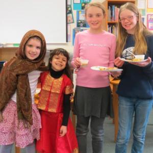 First graders, from left, Freida Camacho and Sophia Scott and fifth graders Lexi Haedrich and Emma Collins enjoy lentil stew and samosas as part of CTL’s Indian Feast. Courtesy of CTL