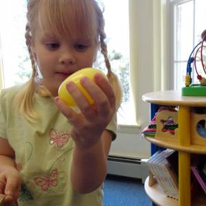 Grace finds the yellow egg with the prize ticket inside! Courtesy of Wiscasset Public Library