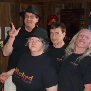 Wicked Blues Band members Jason Simonds (in hat), Annette Rundall, Bill Batty and Patrick Ginnaty pose for a picture in the new band T-shirts during rehearsals for the Road To Memphis Challenge.