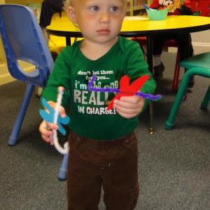 Oliver holds up his two dragonfly creations. Below: Isaac uses pipe cleaners and beads for eyes on his dragonflies. Courtesy of Natalie Castonia