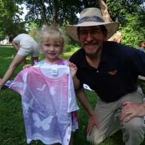 Devon Roy and Jerry Schneider pose with Devon’s butterfly shirt. Below: Jerry Schneider gives instruction on how to make the T-shirt craft. Courtesy of Wiscasset Public Library