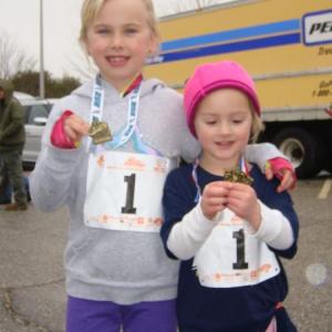 Abigail, left, and Samantha Kopp of Jefferson, both HVNC regulars, hold up their medals after a recent kids race. Courtesy of Andy McEvoy