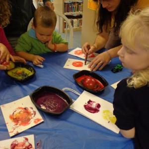 Devon Roy and Chip Segerstrom are busy making their apple prints. Courtesy of Wiscasset Public Library