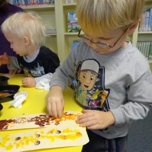 Brothers Xzavier and Oliver Ordung are enjoying this week’s craft where they fingerpainted corn cobs to make decorative door hangings. Courtesy of Natalie Castonia