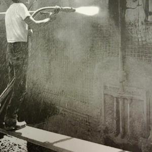 In a photo from the 1950s, a worker sprays cement at the Nequasset Dam. The currently problematic valve can be seen at the right of the photo. Courtesy of Bill Potter