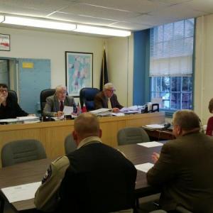 Sheriff Todd Brackett (center, back to) provides information to Lincoln County Commissioners. JANE CARPENTER/Boothbay Register
