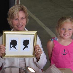 Artist Ruth Monsell holds a silhouette of a young subject and her brother. Courtesy of Ruth Monsell