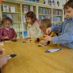 Josee Feder, Margaret Burke, Xzavier Ordung and Graham Burke make penguin puppets using heart shape parts. Courtesy of Natalie Castonia