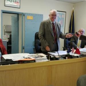 Chairman of Lincoln County Commissioners, William Blodgett (standing) receives the official meeting gavel from County Administrator John O’Connell (far right) after his election. JANE CARPENTER/Boothbay Register
