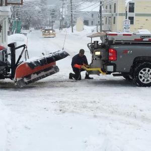 On Thursday morning, Feb. 5, on top of all the other frustrations due to one snowstorm after another during the past two weeks, a Boothbay Harbor Public Works vehicle broke down on the intersection of Townsend Ave. and Union Street. Here, one public works employee hooks his truck up to another public works truck to be towed to the Good ‘N You garage across the street. In the distance more trucks, mostly with plows, can be seen heading down Townsend Avenue. SUZI THAYER/Boothbay Register
