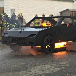 A team of firefighters approaches the blazing car during car fire training on April 16. KATRINA CLARK/Boothbay Register