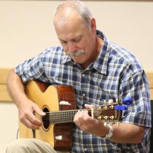 Volunteer Rich Limouze plays his acoustic guitar in the Milestone Café on the Miles Campus of LincolnHealth on Tuesdays. Courtesy of Alan Crowell