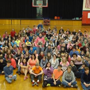 Shalimar Poulin, holding flowers, is surrounded by the student body of Wiscasset High School. Courtesy of Ridge Barnes