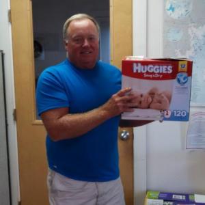 Tom Wilson of the Boothbay Region Food Pantry receives diapers from United Way’s Diaper Project. Courtesy of Maria Hinteregger