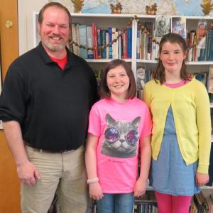 Middle school teacher Glenn Powers with Katie Sanborn and Lacey Brune, winners in the Letters About Literature contest. Courtesy of Scott MacDonald