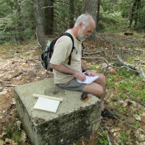 David Kepler of Woolwich enters coordinates into his GPS to help locate a surveying benchmark. Kepler has visited over a hundred geocache locations. Geocaching and benchmarking have become popular year-round outdoor activities. PHIL DI VECE/Wiscasset Newspaper