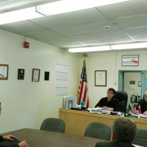 Ethan Wajer of Project Earth, left, briefs Commissioners Mary Trescot and William B. Blodgett (center, facing) as County Administrator John O’Connell and Deputy Administrator Deborah Tibbetts (right) listen. JANE CARPENTER/Boothbay Register
