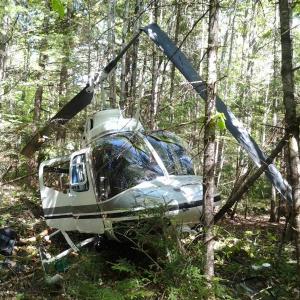 The National Transportation Safety Board has released its probable cause report on the May 30, 2014, forced landing of this helicopter in the wood of Whitefield. Courtesy of Kathleen Woodbury helicopter, Whitefield, Maine