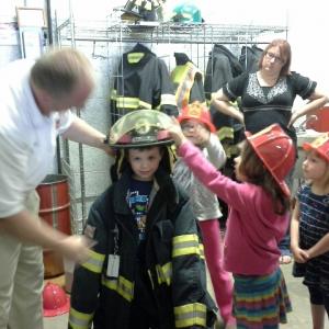 One of the Healthy Kids students tries on some fireman’s gear in Waldoboro. Courtesy of Lucy Smith
