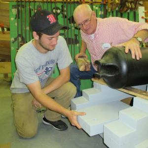 Chayse Reed and Rob Cronk, Wiscasset High School technology education teacher at work recently on Wiscasset’s cannon. PHIL DI VECE/Wiscasset Newspaper