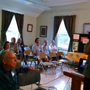 Energy expert Paul Kando (standing) talks about solar power on June 17. Courtesy of Susan van Alsenoy