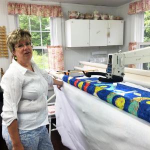 Deb Boucher in her Edgecomb studio, next to her long arm quilting machine. SUZI THAYER/Boothbay Register