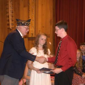 William Cossette, left, presents the American Legion Award to Natalie Corson, middle, and Matthew Smith during the last Wiscasset Middle School eighth grade graduation. BEN BULKELEY/Wiscasset Newspaper
