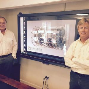 Peregrine Turbine Technologies co-founders Bob Brooks, left, and David Stapp on Aug. 18 stand near a screen image of the technology they and eight other staff have been developing at the firm’s office at Wiscasset Municipal Airport. SUSAN JOHNS/Wiscasset Newspaper Peregrine Turbine Technologies, Bob Brooks, David Stapp