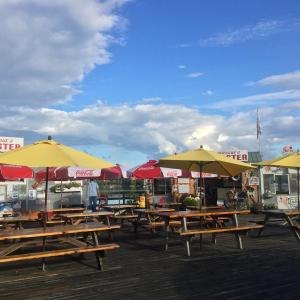 Tables with umbrellas on a wharf over Wiscasset harbor at Sprague’s Lobster can accommodate over 100 happy customers. SUZI THAYER/Wiscasset Newspaper