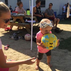 With mom Ashlyn Lewis of Wiscasset at her side, Gwen Lewis, 1, is on the sidelines but focused. The two were at Jones Sand Volleyball Court on Suki Lane Sept. 19 for the first annual Dean Snell Cancer Foundation Volleyball Tournament. The event raised $800, Julie Jones said. SUSAN JOHNS/Wiscasset Newspaper
