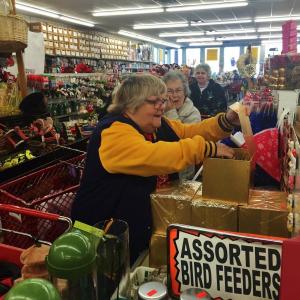 Wiscasset’s Connie Brewer checks out what’s inside a box as fellow Early Bird shoppers look on, at Big Al’s on Route 1 Saturday morning, Nov. 14. SUSAN JOHNS/Wiscasset Newspaper