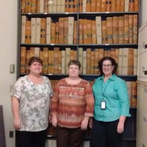 Standing in front of the Lincoln County court records between 1760 and 1871 are, from left, Susan Hodgdon, probate clerk, Catherine Moore, probate register and Karen Robbins, deputy register. JANE CARPENTER/Boothbay Register